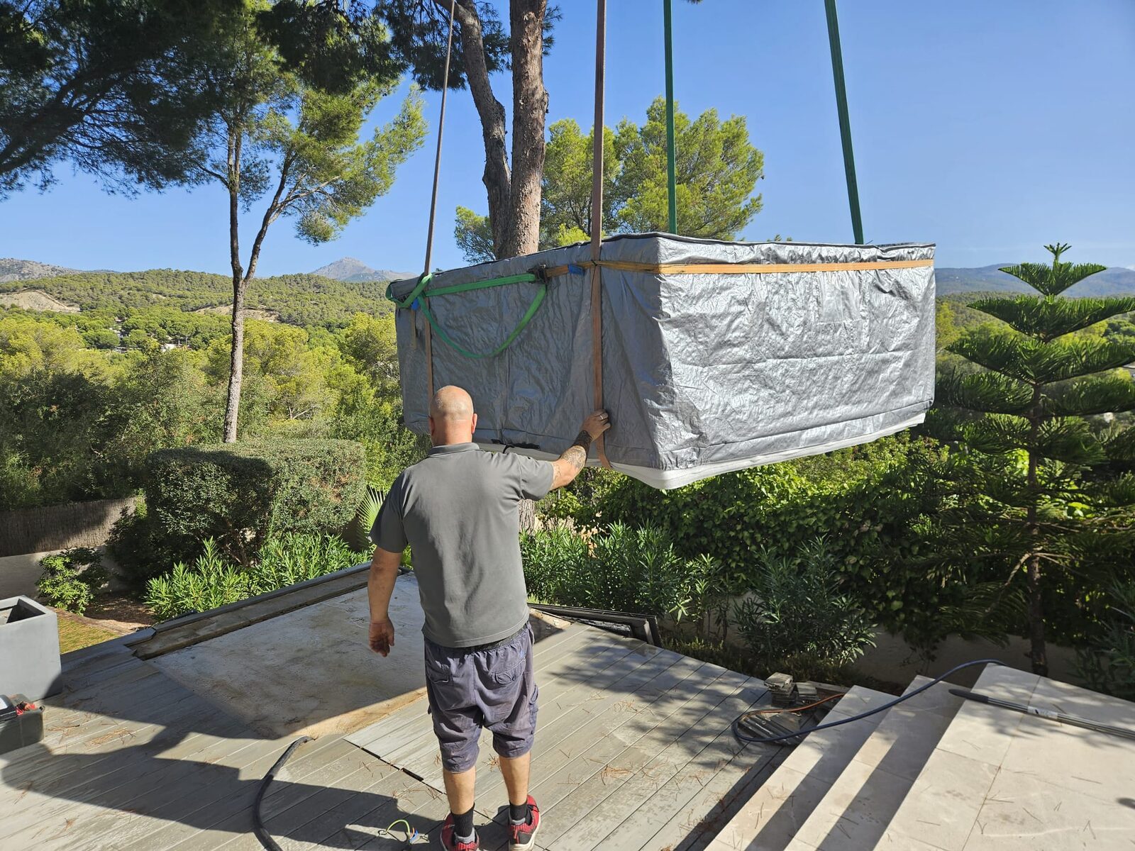 The new spa, wrapped for protection, craned in and guided by hand at Costa de la Calma