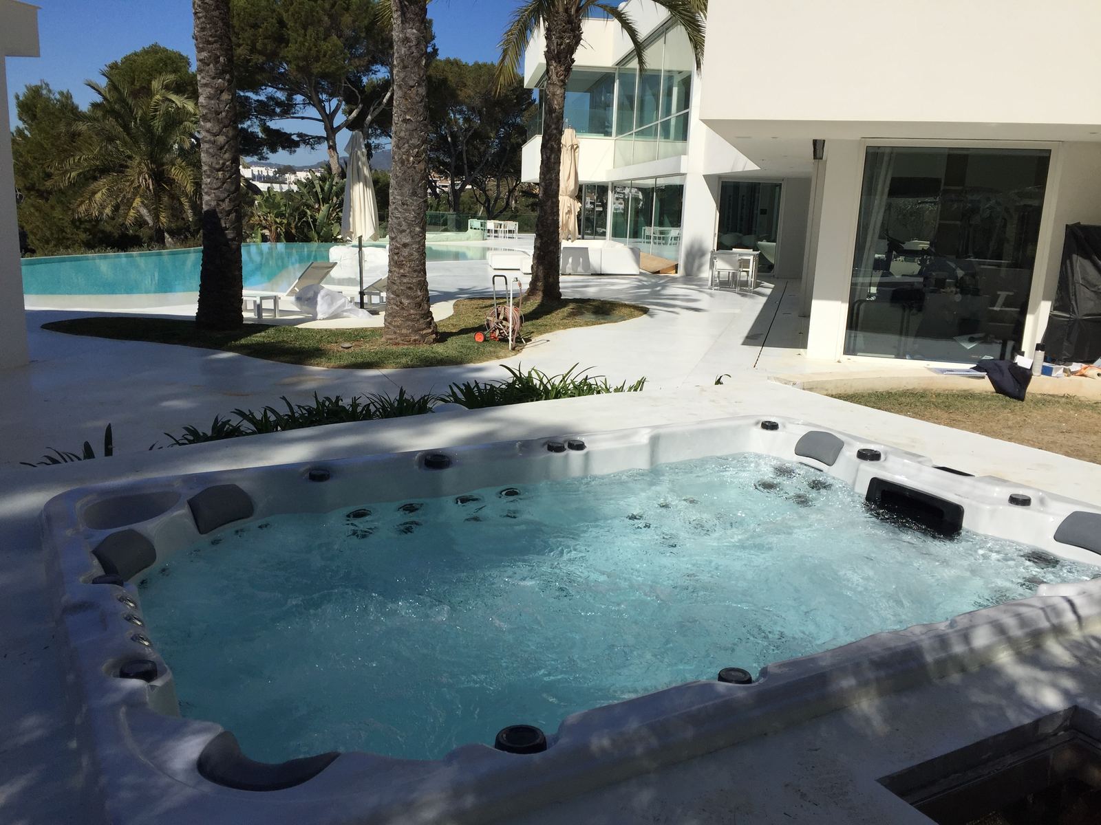 Modern property hot tub installation with poolside lounge in Santa Ponsa
