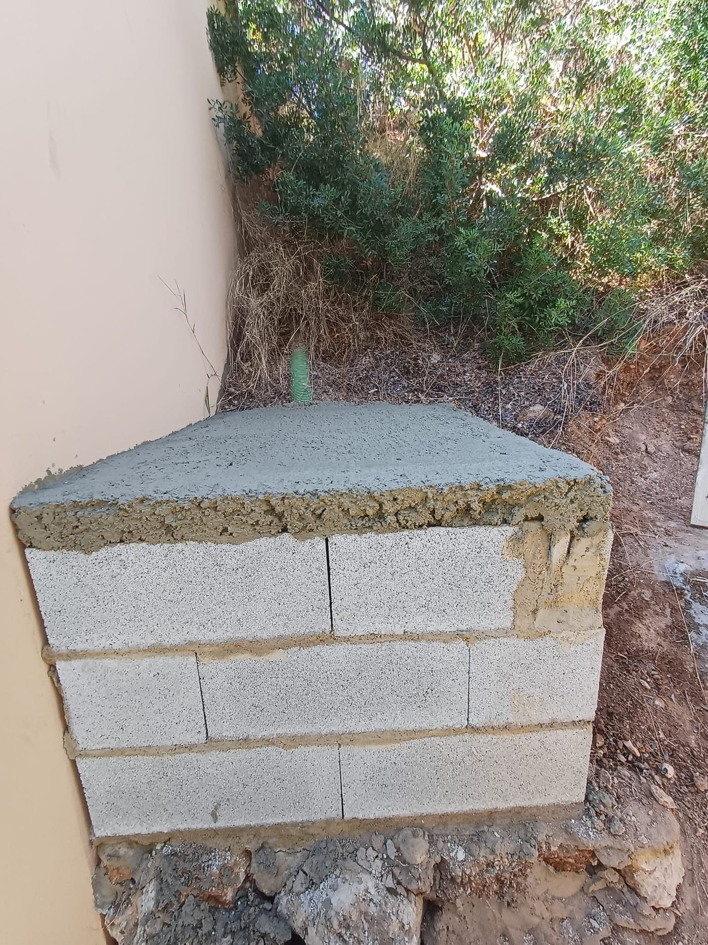 The heat pump installed on its own level base, connected to the whirlpool